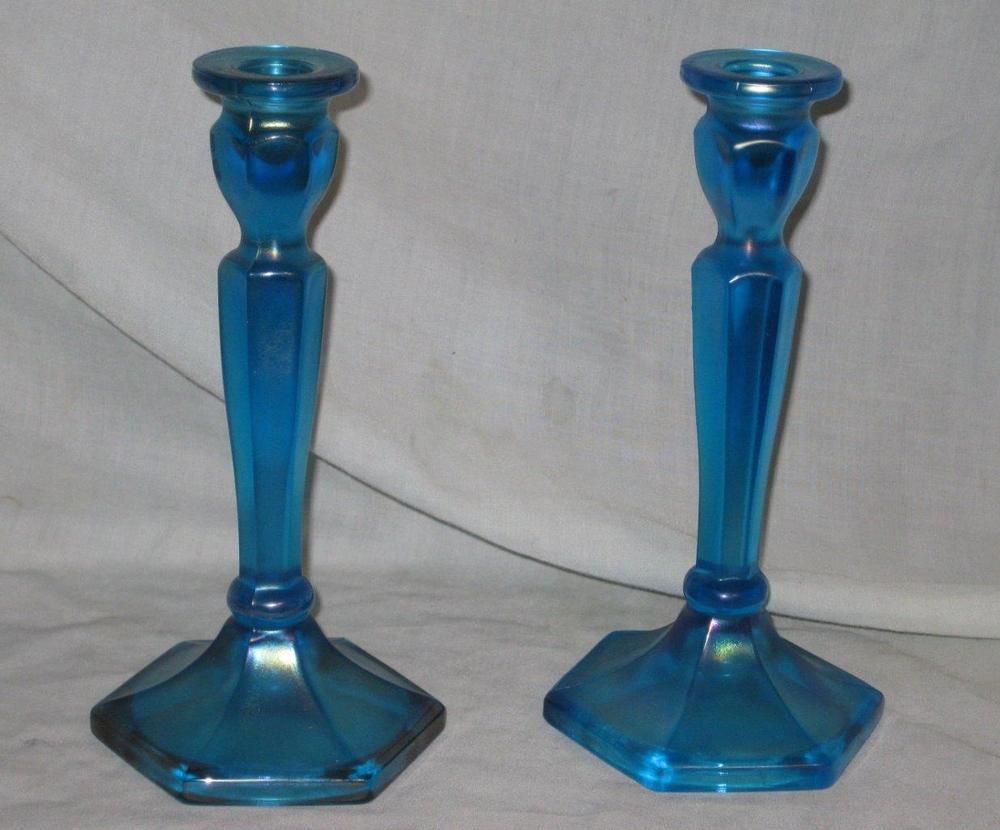These are two matching sapphire blue Carnival Glass candlesticks. They These are two matching sapphire blue Carnival Glass candlesticks. They