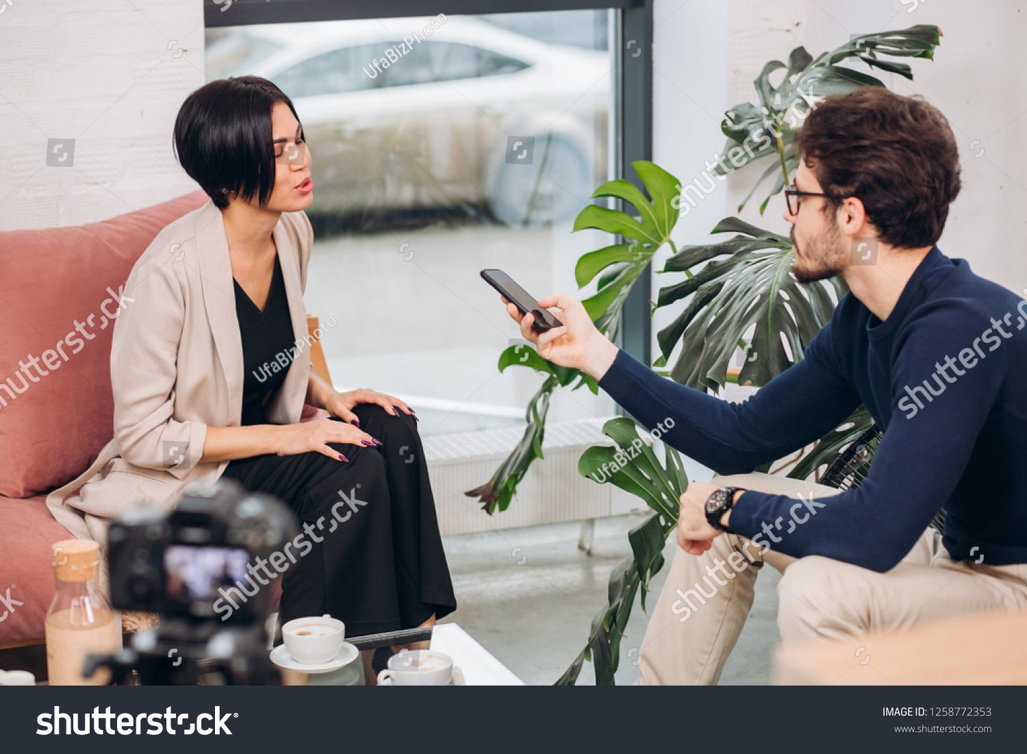 Young Ambitious Journalist Conducting An Interview Indoors