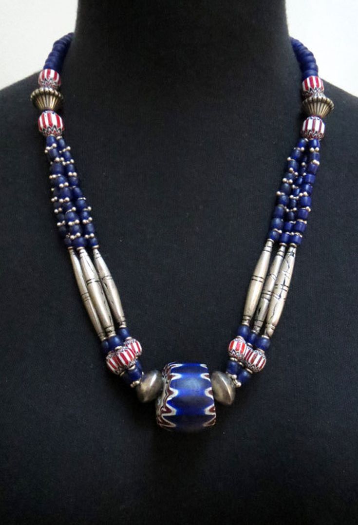 by Luda Hunter | Large 6 layer antique Chevron Venetian glass trade bead, combined with red and white striped vintage chevrons, Ethiopian coin silver beads, Hill tribe spacer beads, Indonesian blue glass beads and Indian silver beads | 315$ African Trade Bead Jewelry, African Trade Beads, Bead Jewellery, Beaded Jewelry, Jewelry Necklaces, Beaded Necklace, Beaded Bracelets, Tribal Necklace, Tribal Jewelry