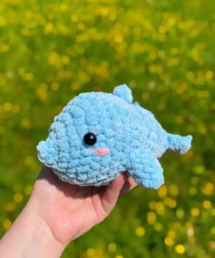Let’s make this cute crochet dolphin, it is the most adorable aquatic decoration, if you love marine life or if you have kids who love plushies and toys, here is the right place for you! The body and head are made in one piece, and then the side fins, top fin, and back fins are made and assembled at the end. Materials needed for this pattern are Dolphin baby yarn, a 4mm crochet hook, and safety eyes, if you need to make a smaller/ bigger dolphin, you can use finer/ bulkier yarn.