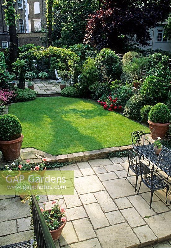 Small Formal Town Garden With Paved Patio Dining Table And Chairs Small Formal Town Garden With Paved Patio Dining Table And Chairs Lawn Containers Borders Arch Dividing Separate At Far E Ideas