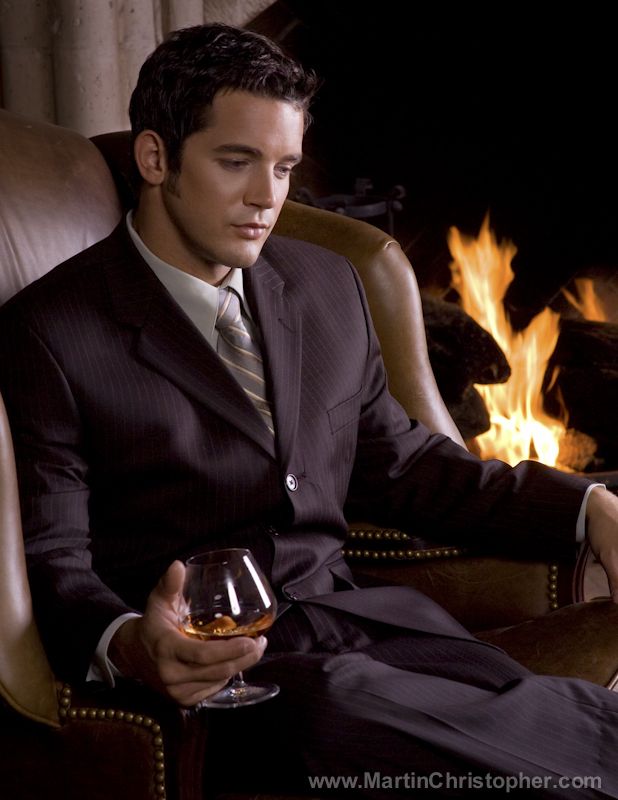 Attractive man in fine suite sipping brandy by the fireplace. | Fashion Photography | Pinterest | Attractive men Fashion photography and Fashion