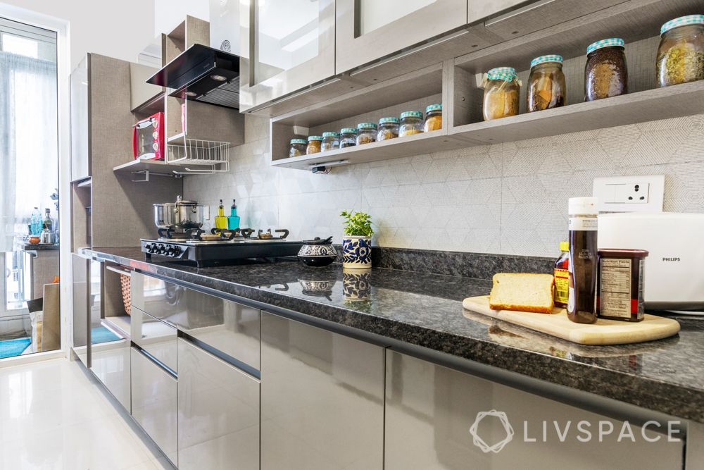 4 BHK flat design-parallel kitchen-wicker basket-laminate finish-frosted glass shutters-open shelves Flat Design, Modern Design, Fabric Wall Panels, Shutter Designs, Wooden Wardrobe, Patterned Chair, Floral Upholstery, Best Kitchen Designs, White Laminate