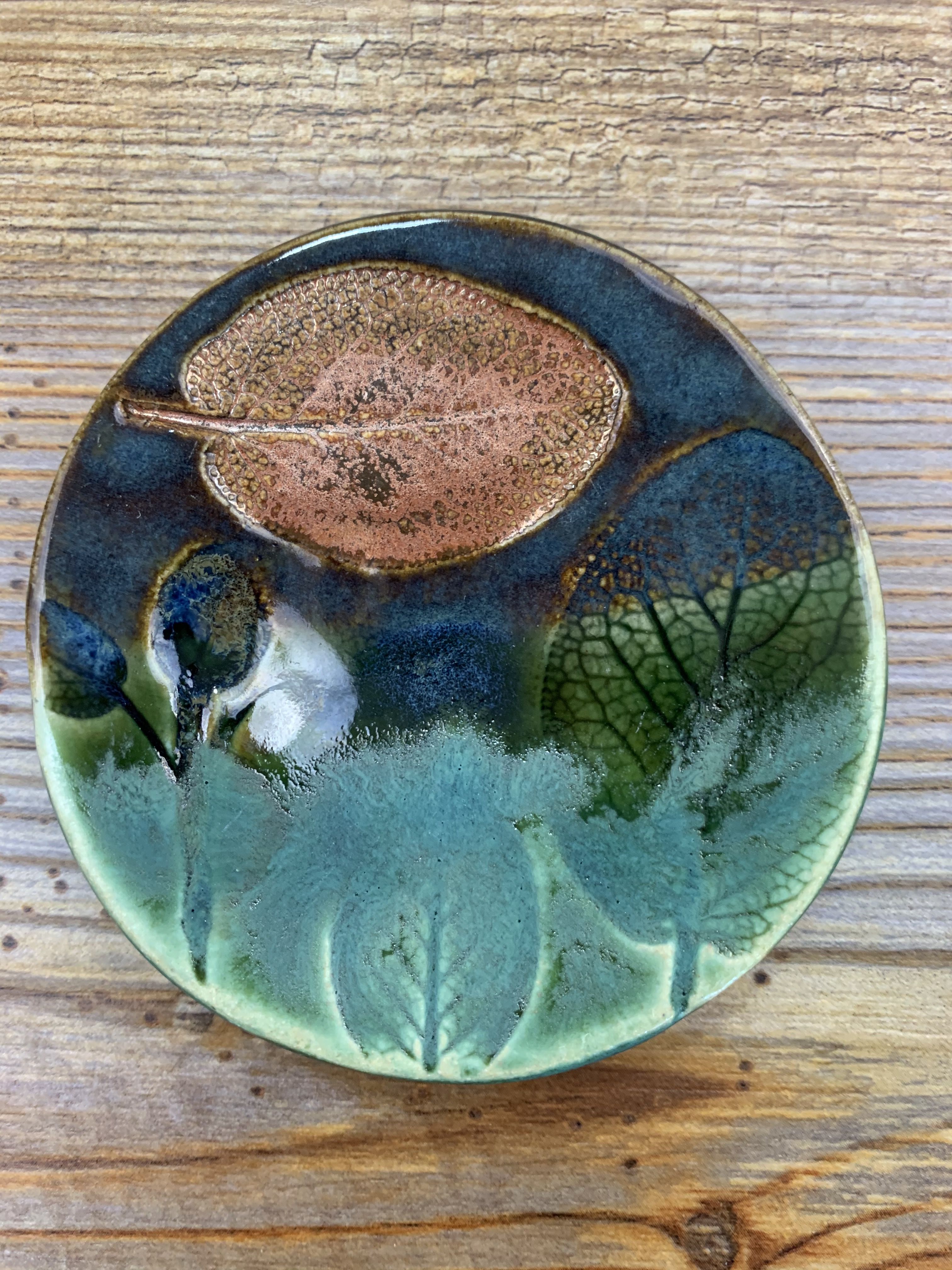 Small artisan made stoneware jewelry dish with hand painted leaf design