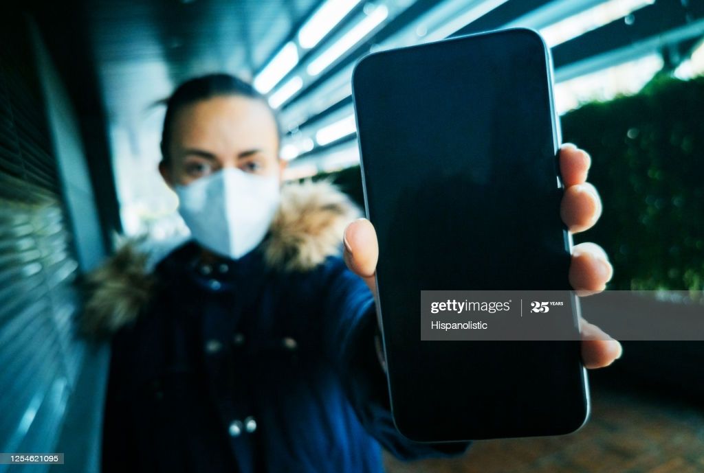Latin American Woman Wearing A Facemask And Holding A Cell Phone Women Wear Camera Photography Face Mask