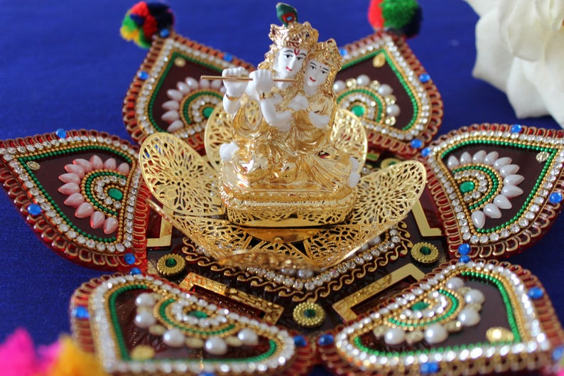 Radha Krishna Idol in white and Gold sitting on Metal Flower | Etsy Can We Keep Radha Krishna Idol In Pooja Room
