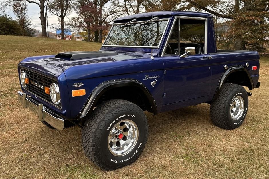 This 1975 Ford Bronco was converted from a wagon to a half-cab pickup under previous ownership and underwent a cosmetic and mechanical refurbishment after being acquired by the seller in 2017. Work included repainting the truck in blue, reupholstering the seats in black vinyl, installing a 302ci V8, and replacing the dual-range transfer case. Additional equipment includes 15" Eagle Alloys wheels, front disc brakes, Bilstein and Wild Horses suspension components, an Edelbrock intake manifold and Transfer Case, Four Wheel Drive, Ford Bronco, Alloy Wheel, Wild Horses, Reupholster, Repainting, Cab, Wagon