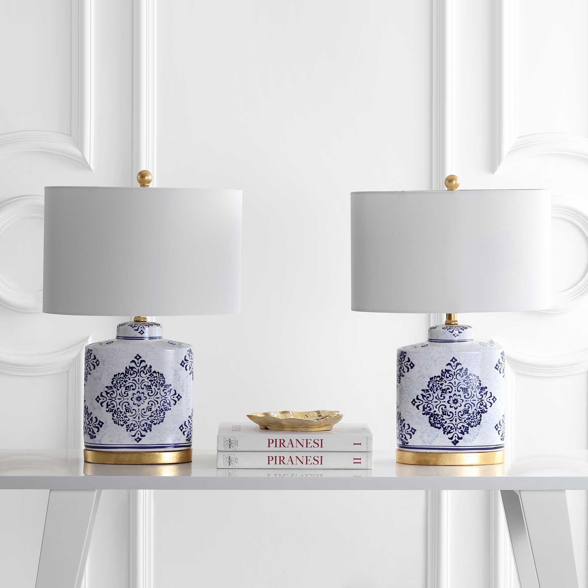 A design classic, this refined table lamp elevates any living room with timeless luxury. Finely crafted with a delicate blue and white pattern on its exquisite ceramic body, it exudes good taste. Its off-white 100% cotton shade and gold finial are complimentary. Dimensions: 16W x 10D x 23.8H Color: Blue/White Material: Ceramic Bulb Wattage: 100W Shipping: Ships within 5-7 days. US only. Return: This item is return eligible within 14 days. Please Comment, Like, or Re-Pin for later 😍💞 nigh White Table Lamp, Table Lamp Sets, Light Table, Blue And White Lamp, Blue And White Living Room, Blue Lamps, White Lamps, Gold Living, Coastal Living