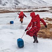 Pictures Of A Place Where No One Should Live #plasticjugs Kyrgyz girls slide plastic jugs back to their family's camp after chopping a hole in a frozen spring to fetch water. Men handle herding and trading; much of the hard labor of daily life falls to the females. #plasticjugs