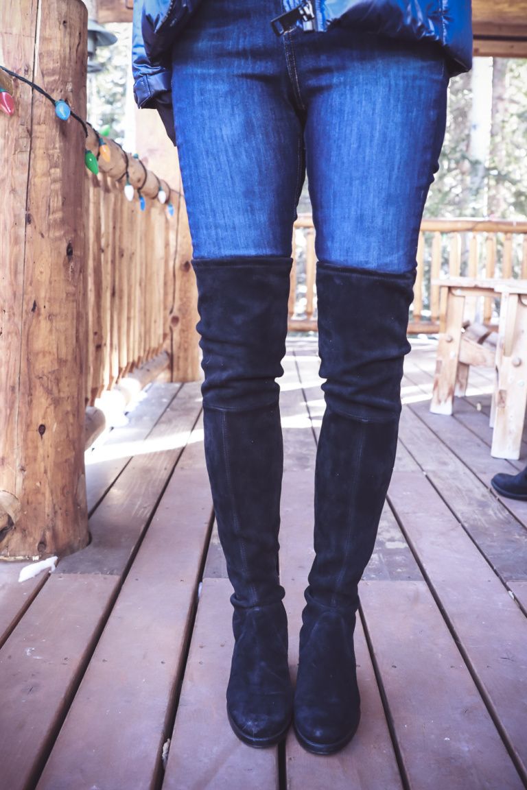 knee high boots with ripped jeans
