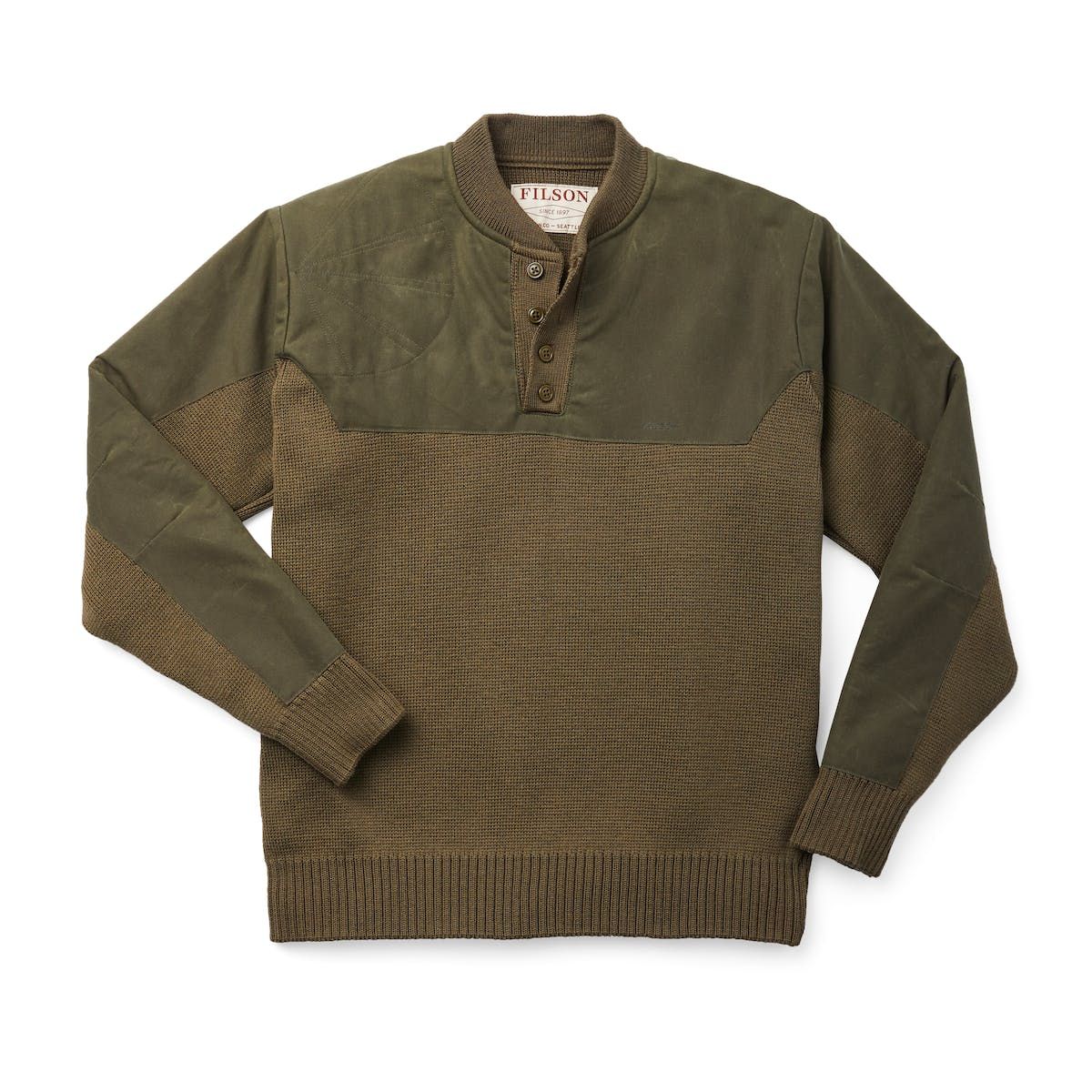 The Filson Henley Guide Sweater, originally conceived by and for waterfowl hunters, is sewn in the USA with 100% merino wool. The waxed-cotton cape, made with our signature oil finish Shelter Cloth from the iconic British Millerain, protects from driving rain and snow. The four-button placket provides ventilation versatility, and the right shoulder shooting patch eases the bite of hot 12-gauge duck loads. The USA-sourced wool comes from merino sheep prized for their long, fine fleece. Merino woo Sweater Shirt, Men Sweater, Light Colored Fabric, Filson, Country Outfits, Country Attire, Knitted Sweaters, Mens Wool Sweaters, Rib Knit