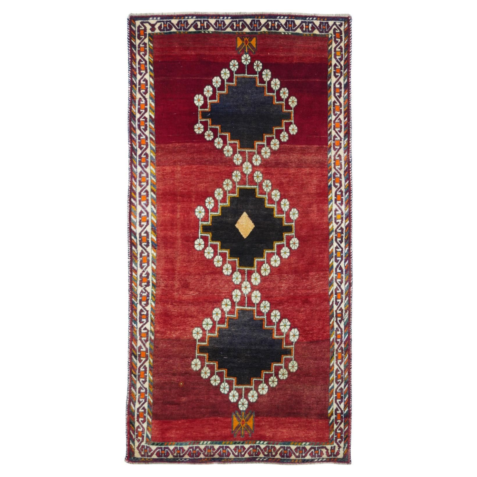 This SW Persian Qashghai tribal scatter shows an abrashed crimson open field centred by a pole medallion of three stepped near black diamonds, edged and joined by simple ecru rosettes. Main narrow ecru border with a reversing, linked rectangular "S" pattern. Moderate tribal weave. Relatively recent. Good condition. Measures: 3'9'' x 7'6''. Gabbeh Rug, Open Field, Black Diamonds, Rosettes, Persian Rug, Crimson, Ecru, Rugs On Carpet, Medallion