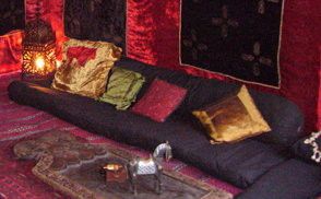 Black Floor Level Sofa With Back Bolster And Colourful Cushions Black Floor Level Sofa With Back Bolster And Colourful Cushions
