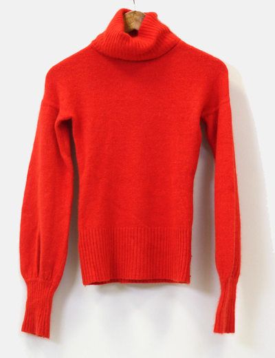 a red sweater hanging on a white wall