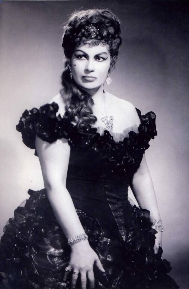 An Old Black And White Photo Of A Woman In A Dress an-old-black-and-white-photo-of-a-woman-in-a-dress