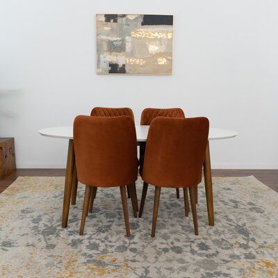 Make this timeless Uber to mid-century modern dining set your home’s newest hub where you can set up your laptop to create an impromptu home office, or where you and your dearest enjoy a warm home-cooked meal. This dining set's high-quality, easy-to-clean smooth solid wood finishes will complement any decor, making this a perfect addition to your breakfast nook, kitchen, or dining room. The dining chairs present a lovely structure for an additional high level of comfort and back support. Availab Beige Dining Chair, White Dining Set, Orange Dining Chairs, Solid Wood Dining Room, Kitchen Dining Sets, Fabric Dining Chairs, Solid Wood Dining Table, Modern Dining Table, Dining Table Chairs