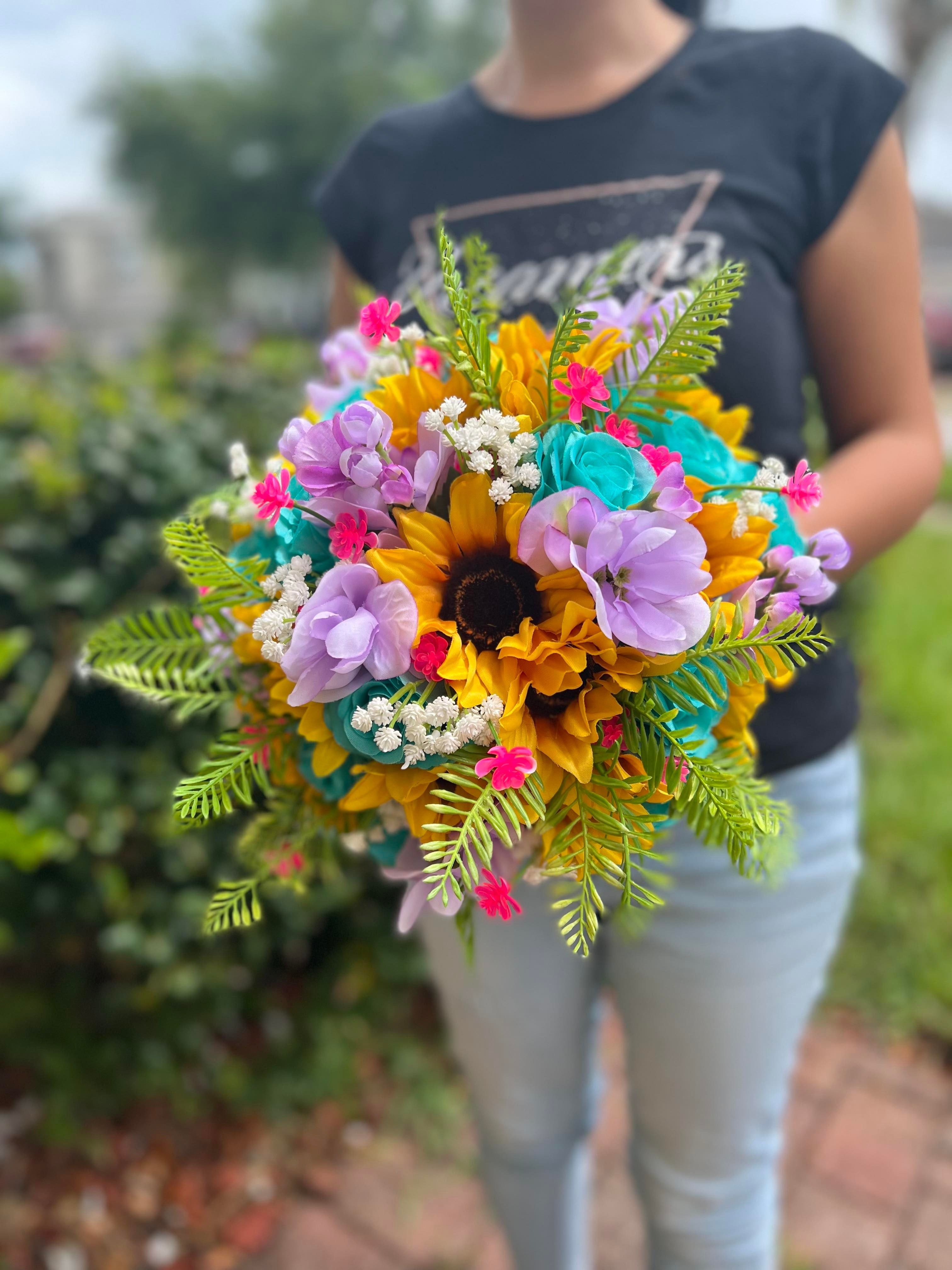 Sunflowers symbolize adoration, loyalty and longevity and the celebration of a wedding is all about these feelings! Sunflowers are known for being “happy” flowers, having them in the most special day of your life completes your happiness.This is a beautiful real touch Sunflowers, Turquoise and Fuchsia Wedding Bouquet, made with the most realistic silk flowers. We can add different colors if you'd like to.The size shown is 10", 8" and 6" Round bouquet and we can do more sizes if you need to.Bouto Sunflower Bridal Bouquet, Purple Wedding Bouquets, Round Bouquet, Making A Bouquet, Rustic Bouquet, Wedding Theme Colors, Happy Flowers, Different Flowers, Make Arrangements