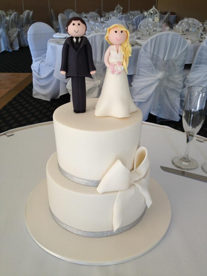 Ivory wedding cake with fondant figurine toppers Ivory wedding cake