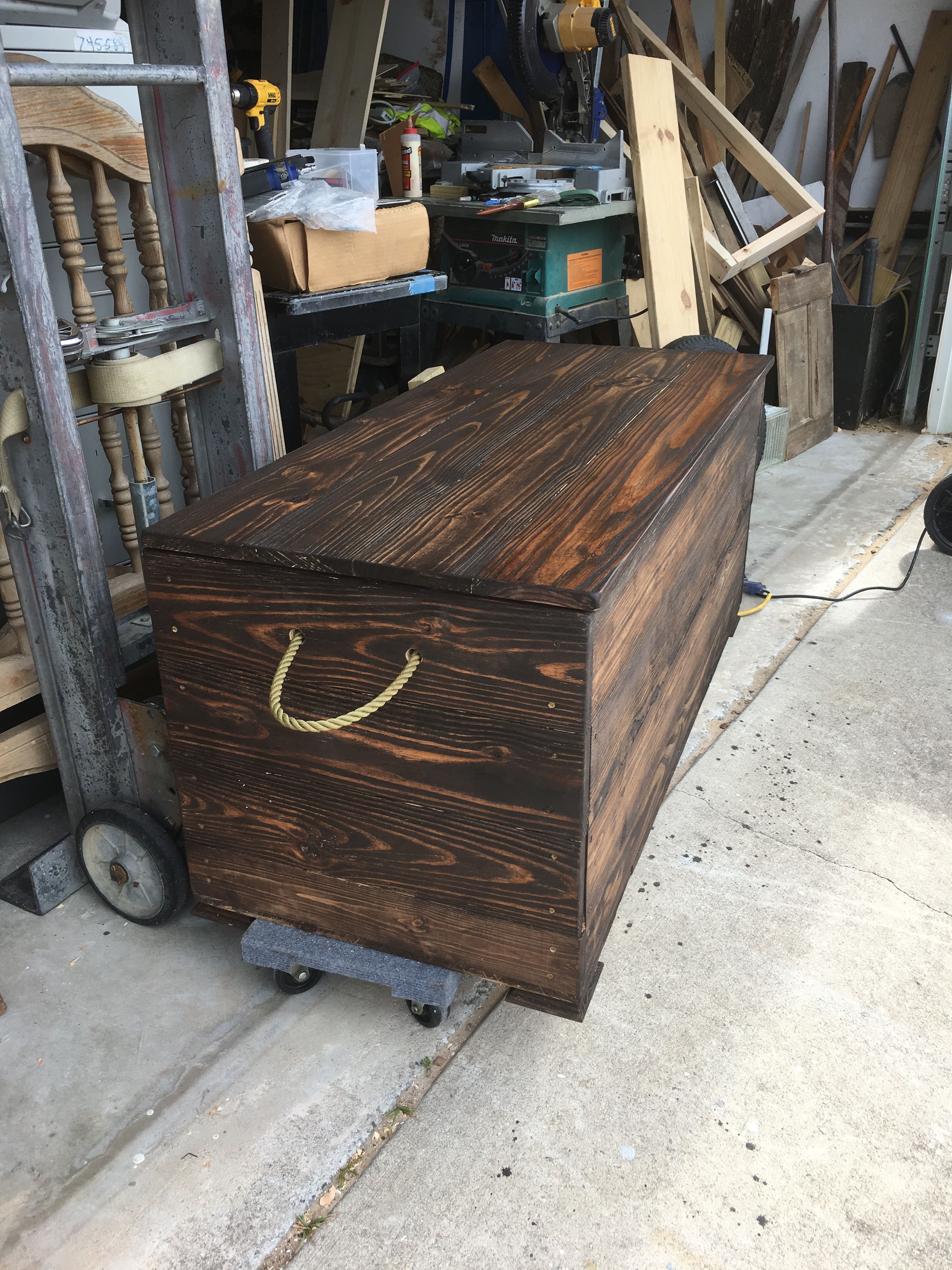 A Wooden Box Sitting On Top Of A Floor Next To A Pile Of Wood Planks A Wooden Box Sitting On Top Of A Floor Next To A Pile Of Wood Planks