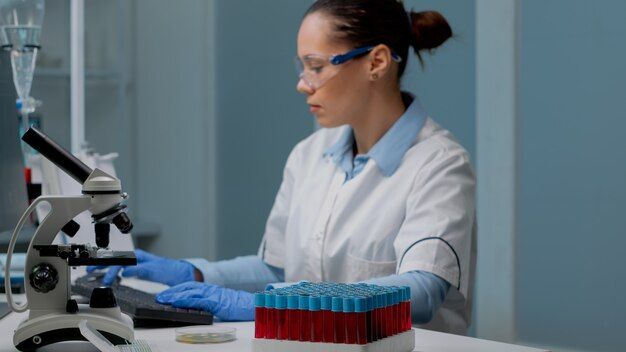 Microbiology specialist using computer i... | Free Photo #Freepik #freephoto #technology #computer #woman #medical Glass Flask, Scientific Experiment, Women Scientists, Used Computers, New Career, Biochemistry, Microbiology, Science Experiments, Free Photos