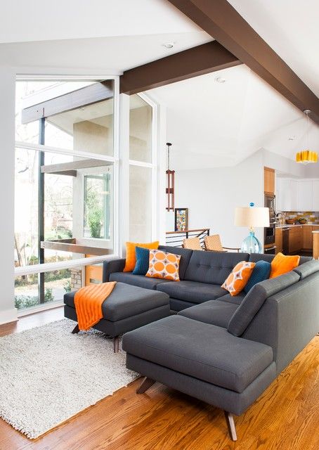 grey couch with orange pillows