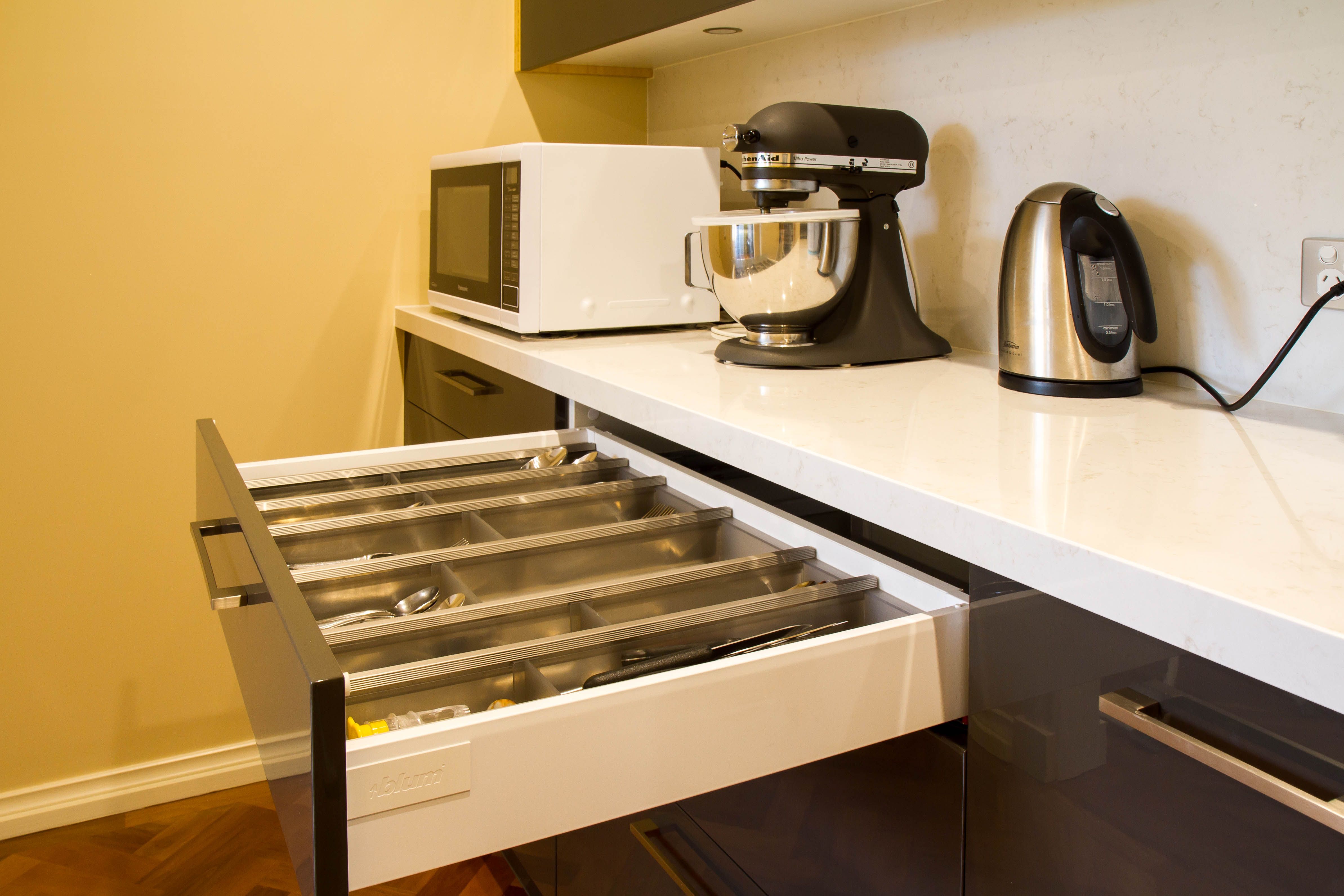 A Compact Contemporary Kitchen With High End Appliances Butler S Pantry And Home Office Desk Small Home Office Desk Functional Kitchen Contemporary Kitchen