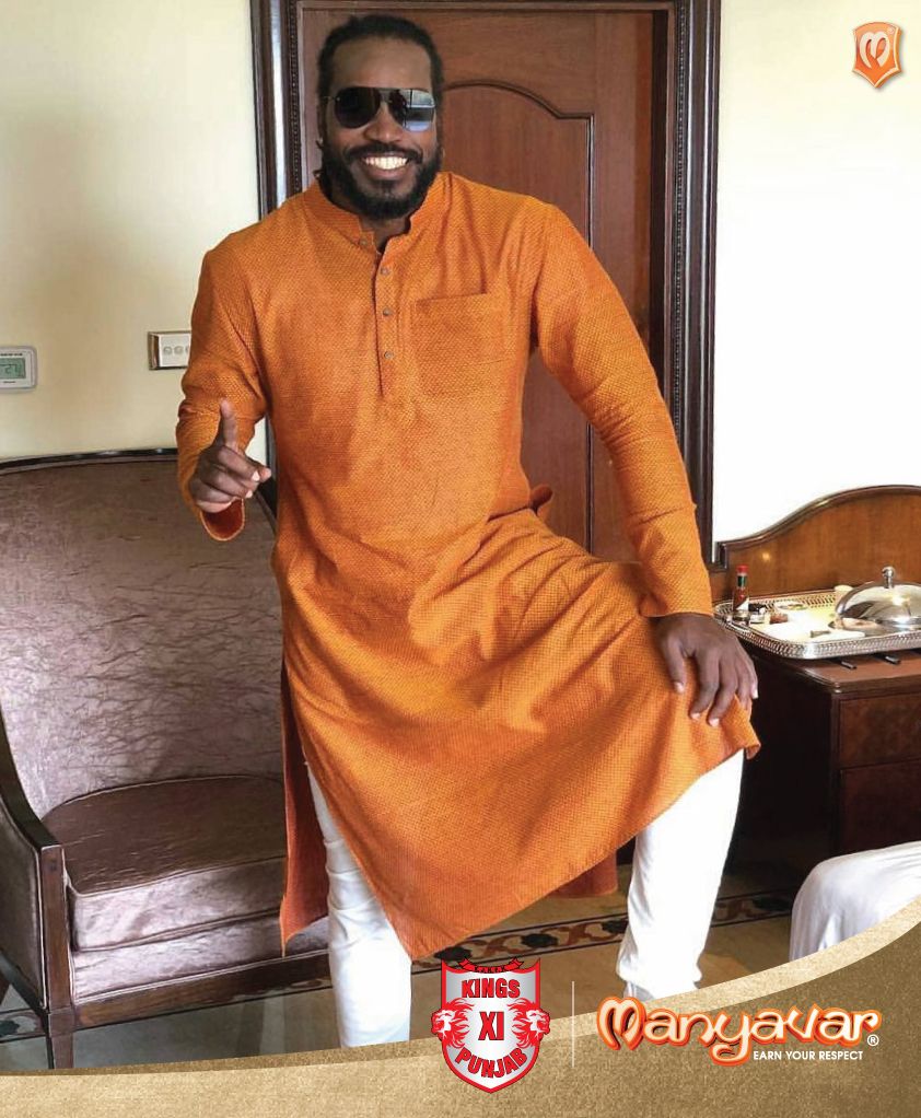 Kings XI Punjab’s Chris Gayle is looking dapper in an Orange Kurta from the house of Manyavar. Look at that exuberant beam on his face and the effortless style he’s carrying off this traditional kurta with. Tell us what you think of his desi look? #Kurta #KurtaJacketSet #CelebrationWear #Cricket #IPL2018 #ChrisGayle #KXIPunjab Buy Kurta Online, African Clothing For Men, Looking Dapper, Mens Pajamas, Men Online, Effortless Style, Wedding Designs, Cricket, Pajama Set