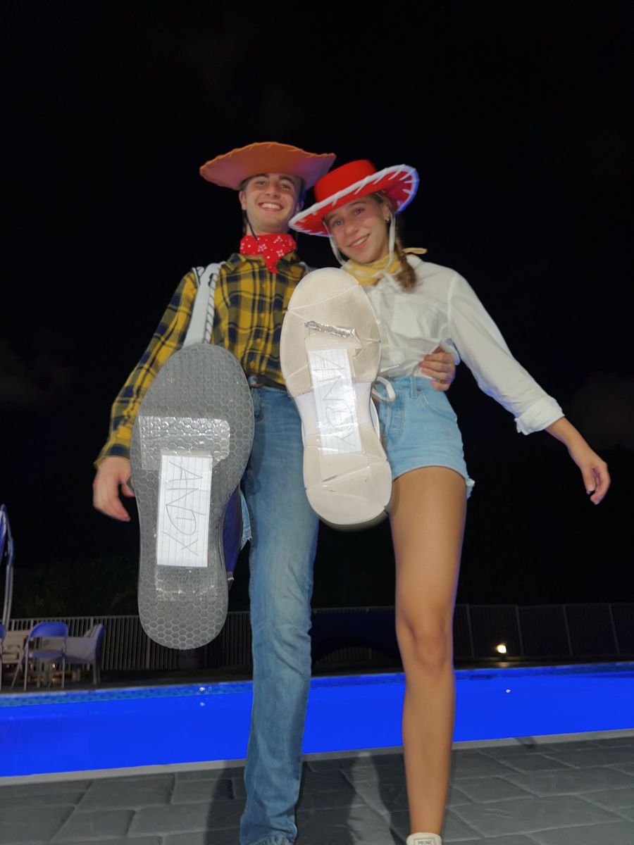 A Man And Woman Dressed In Cowboy Hats Pose For A Photo With Their a-man-and-woman-dressed-in-cowboy-hats-pose-for-a-photo-with-their