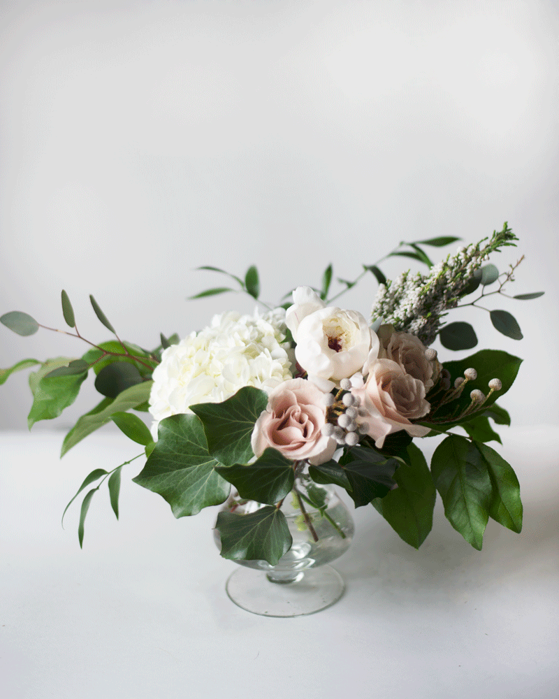 Wedding centrepiece with white hydrangea, eucalyptus, quicksand roses and white ranunculus in a clear glass pedestal vase Ranunculus Centerpiece, Succulent Wedding Centerpieces, Reception Centerpieces, Centerpiece Ideas, Small Centerpieces, Succulent Bouquet Wedding, Wedding Bouquets, Flowers Bouquet, Unique Wedding Flowers