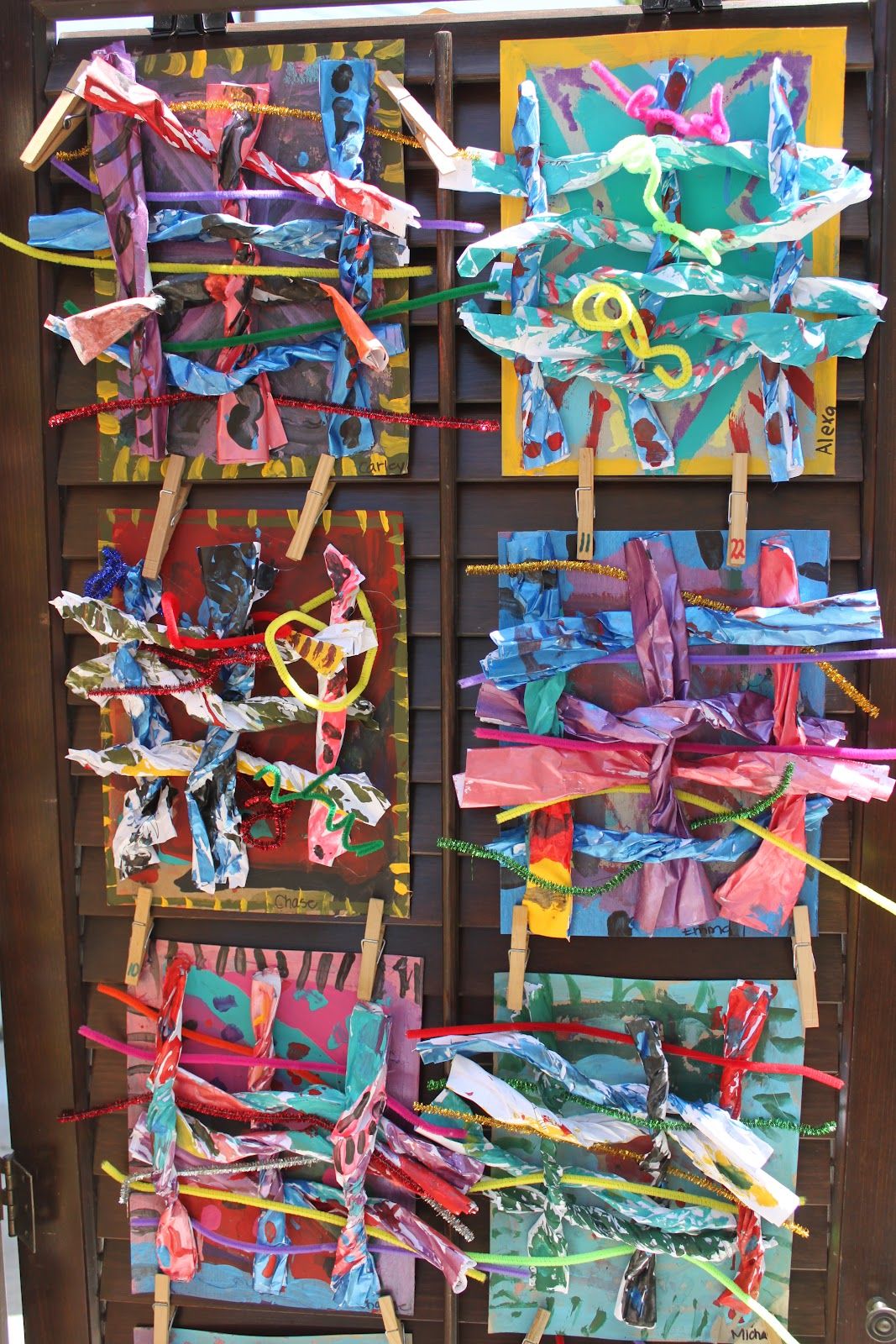 Several Colorful Pieces Of Paper Hanging From Clothes Pins Several Colorful Pieces Of Paper Hanging From Clothes Pins