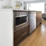 Kitchen Gallery: White Cabinets with a Wooden Frame Accent and Island #opengalleykitchen