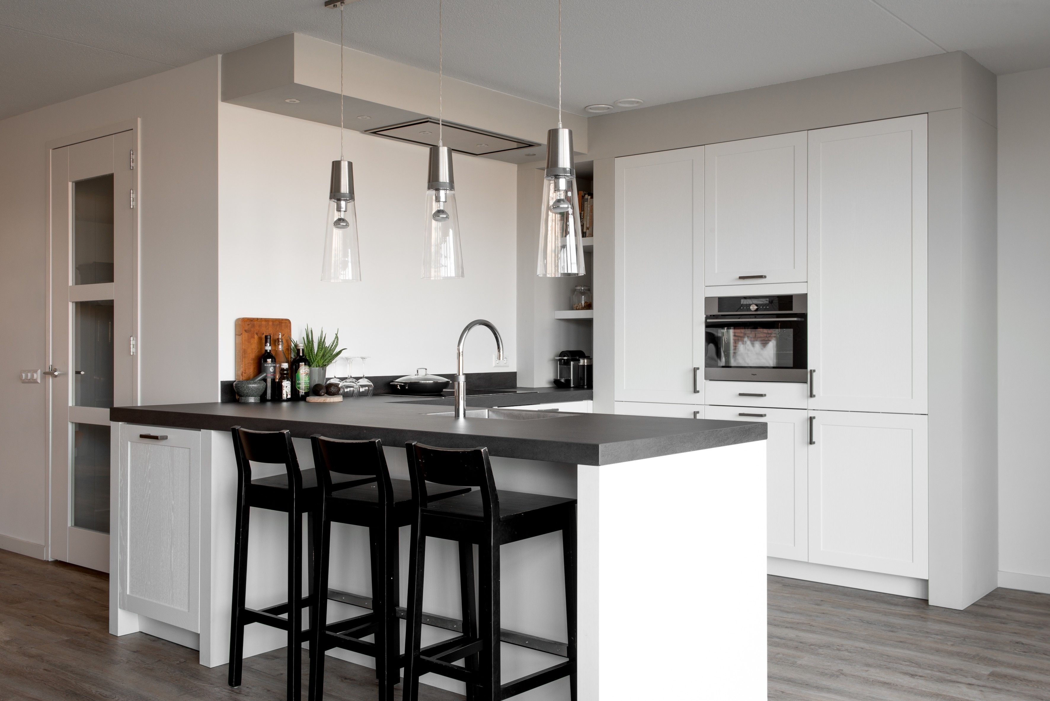 Deze witte U-keuken combineert zowel moderne als ...