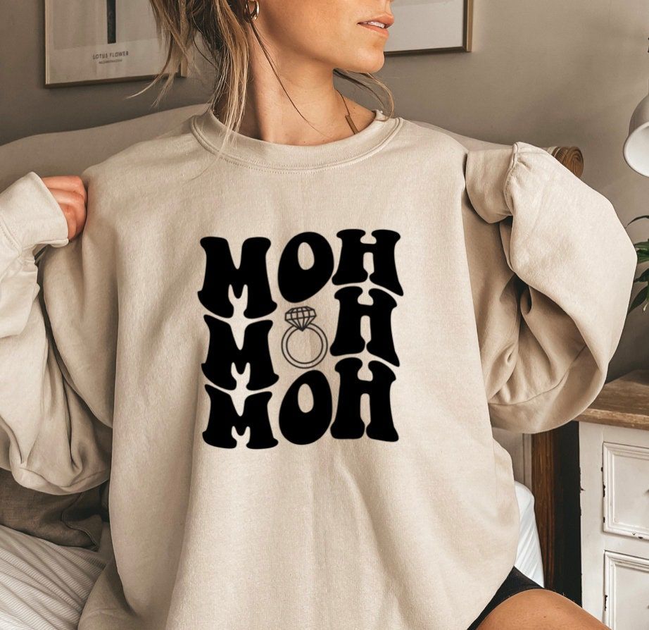 Due to supply chain disruptions, our apparel BRANDS and COLORS may vary than what is shown in our store. Shirt color can vary, and print / design color can vary. Color Disclaimer Actual colors may vary from our listing photo and the final product. We cannot guarantee that the color you see accurately illustrates the true identical color of the product. Maid Of Honor Sweatshirt, MOH Matron of Honor shirt, Bridesmaid proposal gifts, Wedding day Bridal shower t-shirt, Bachelorette party gift ------ Bridal Bachelorette Party, Bachelorette Outfits, Bridal Party Proposal, Bachelorette Weekend, Bridal Party Gifts, Gifts For Wedding Party, Wedding Wishes, Bridesmaid Proposal Gifts, Bridesmaid Shirts