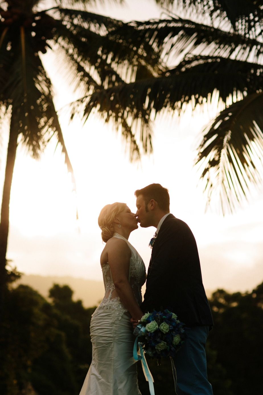 Couple kissing at their beach wedding at Thala Beach Lodge in QLD