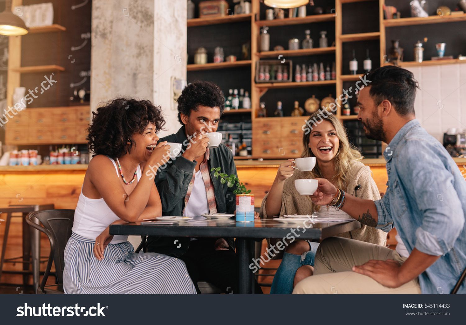 Diverse Group Of Friends Enjoying Some Coffee Together In A Restaurant diverse-group-of-friends-enjoying-some-coffee-together-in-a-restaurant