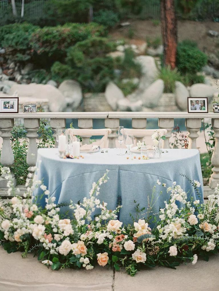 Sweetheart Table With Blue Linens And Clusters Of Fresh Flowers Sweetheart Table With Blue Linens And Clusters Of Fresh Flowers
