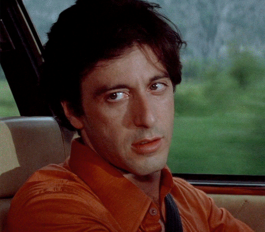 a man sitting in the back seat of a car
