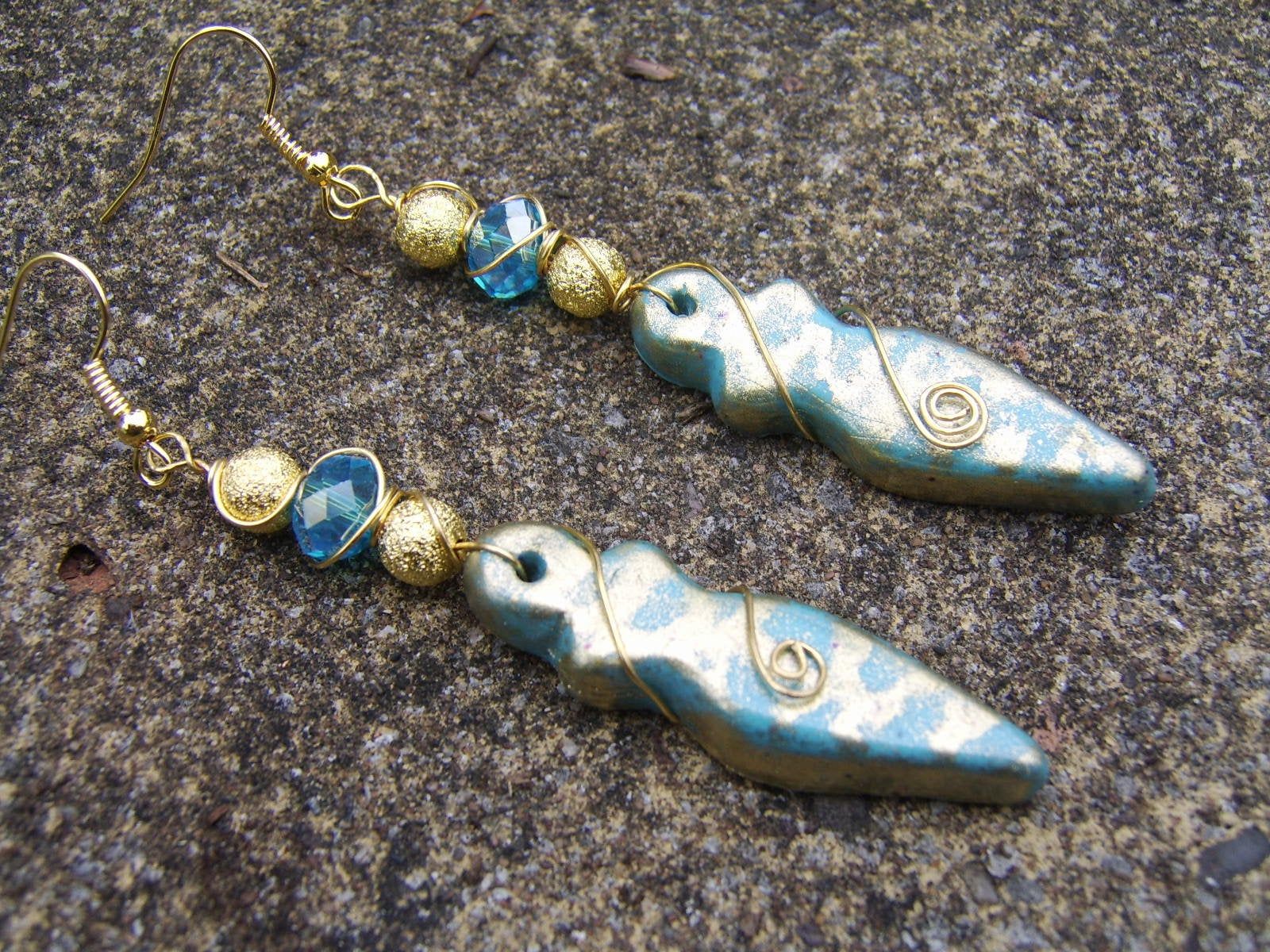 Spiritual earrings with fertility goddess charms and combined with water bleu clay beads