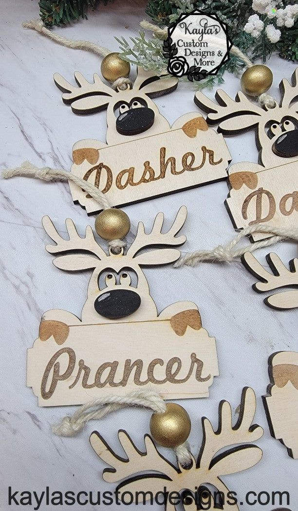 Custom Cute Reindeer Ornament Give as a gift, hang from your rearview mirror as a car charm, hang from your tree. Finished size: 4"x3.5" At checkout please leave a note of what name or style you would like. If you would like a bow added to a girl please let me know the color you want the bow. Full sets will contain all 9 reindeer as pictured. Material: wood (As with all wood products the wood grain may vary between pieces.)Custom items make great gifts for; Birthday, Christmas, Anniversary, Just Reindeer Ornaments, Santa And Reindeer, Christmas Tag, Custom Christmas, Business Colors, Prancer, Custom Ornament, Car Charms, Cupid