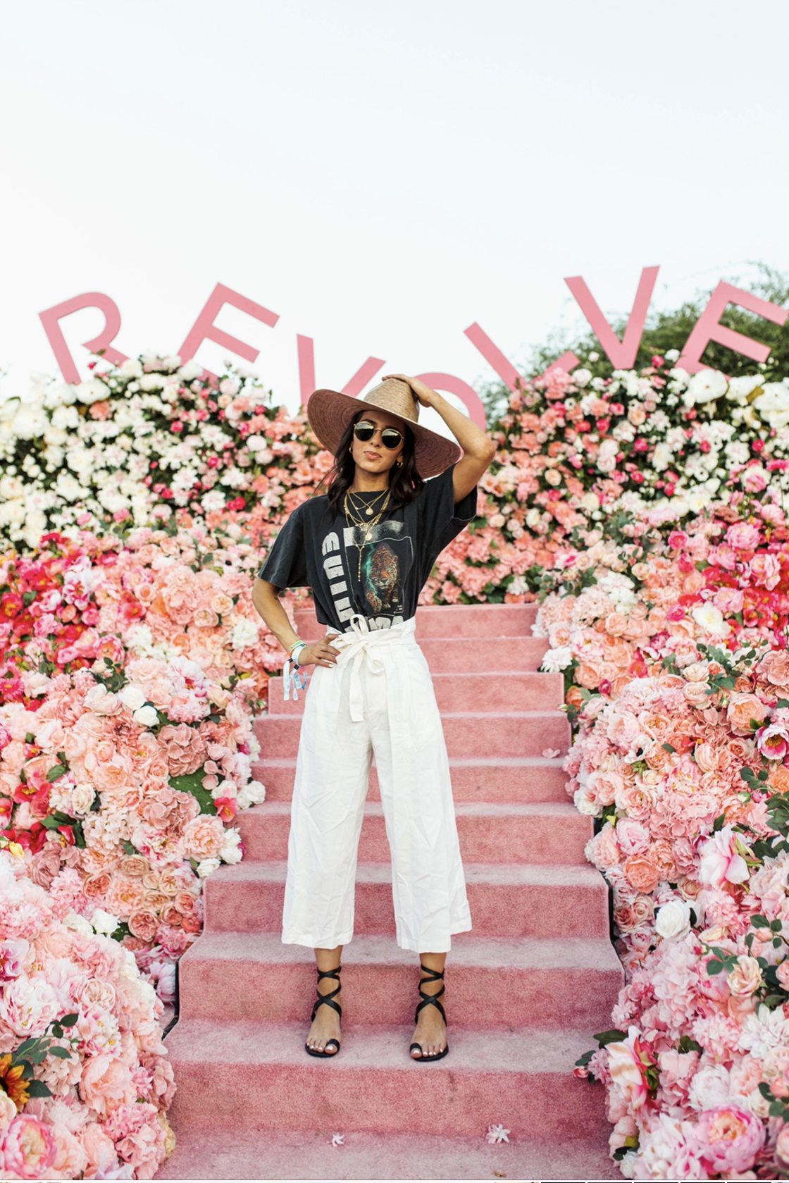 Revolve Festival Looks featured by top US fashion blogger Ashley Hodges; Image of a woman wearing black tee and white pants. festival fashion | summer fashion | AshleyTerk | Festival Style, Festival Mode, Music Festival Fashion, Festival Looks, Festival Outfits, Concert Outfits, Music Festivals, Cool Summer Outfits, Summer Outfits Women