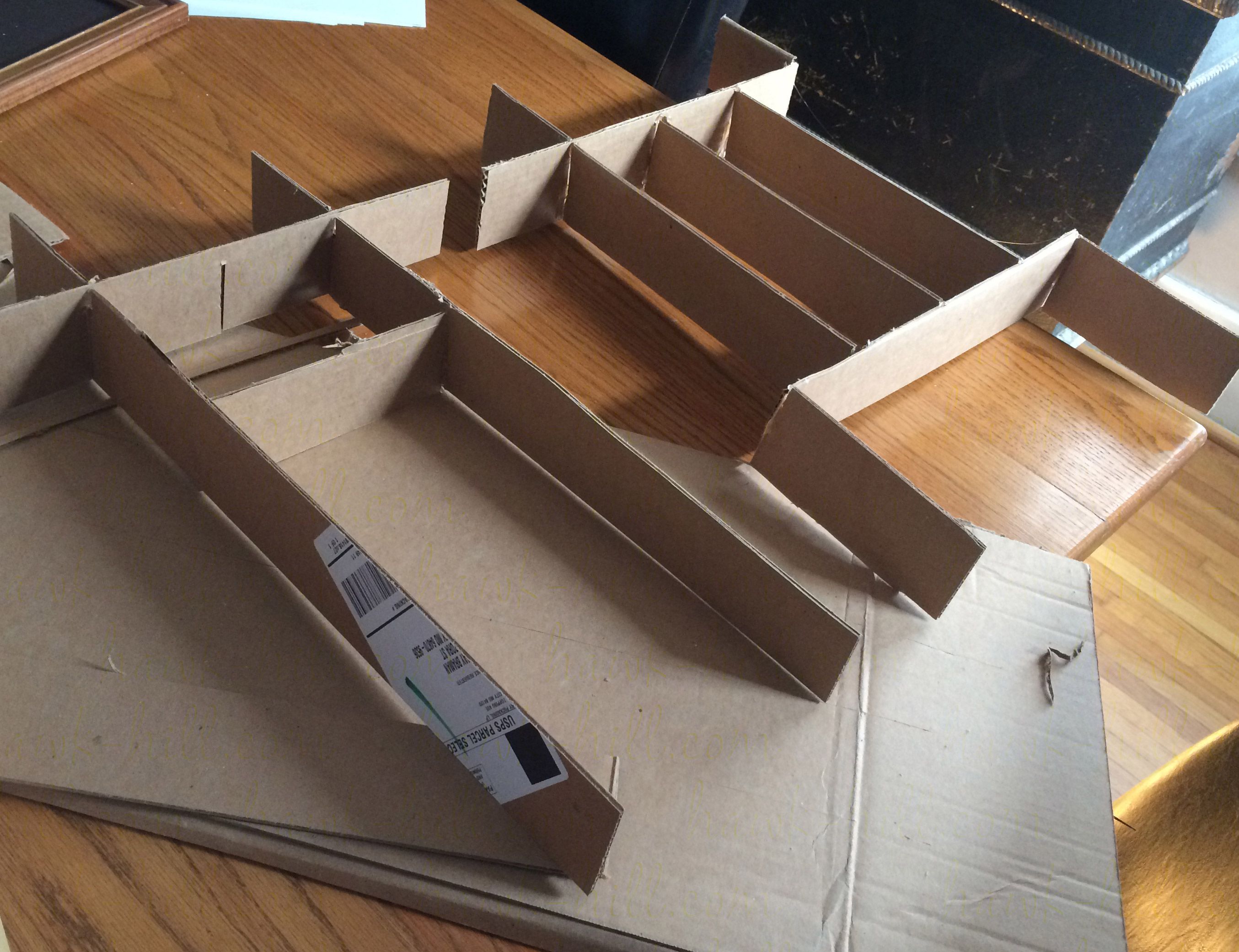 Use cardboard strips to plan your drawer dividers before cutting