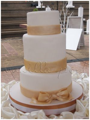 A simple 3 tier fondant wedding cake with a taller 2nd tier