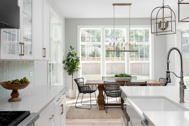 An open floor plan that allows for a seamless transition from kitchen to the breakfast nook This space also allows for plenty of natural light for a bright and airy cooking and dining space Cabinet Paint Colors, Wall Paint Colors, Bedroom Paint Colors, White Oak Hardwood Floors, Bath Tiles, Coastal Kitchen, Gorgeous Kitchens, Free Standing Tub