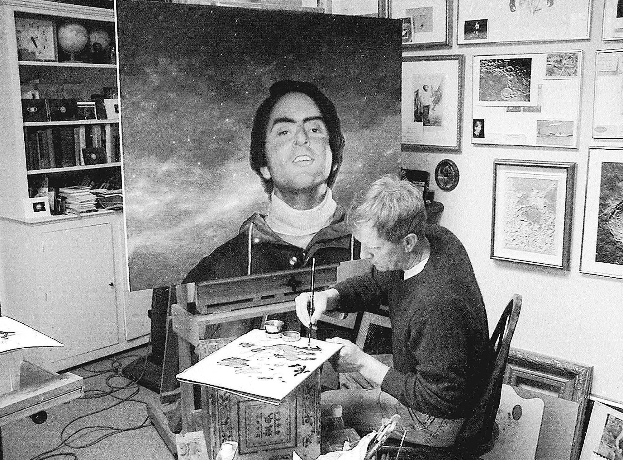 artist greg mort works on a portrait of astronomer carl sagan that carl sagan works
