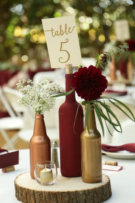 Gold and burgundy wine bottle centerpiece on wood round- decor idea from vineyard wedding from Gale Vineyards in California #winecountryweddings #VineyardWedding #winerywedding #galevineyards Wine Bottle Centerpieces, Wedding Wine Bottles, Wedding Table Centerpieces, Diy Wedding Decorations, Flower Centerpieces, Centerpieces Outdoor, Wine Centerpiece, Inexpensive Wedding Centerpieces, Ceremony Decorations