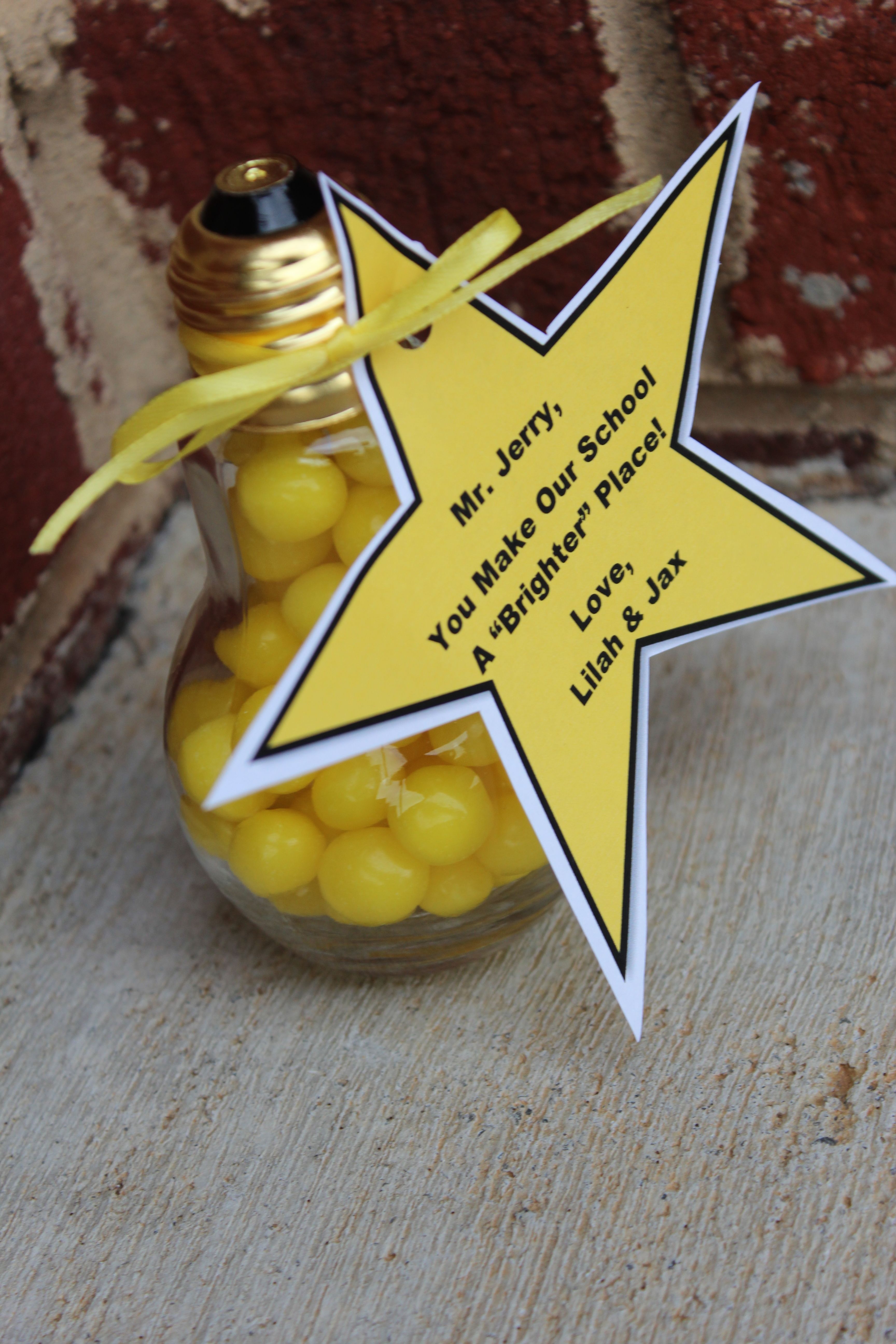 a jar filled with yellow candies sitting on top of a wooden table next