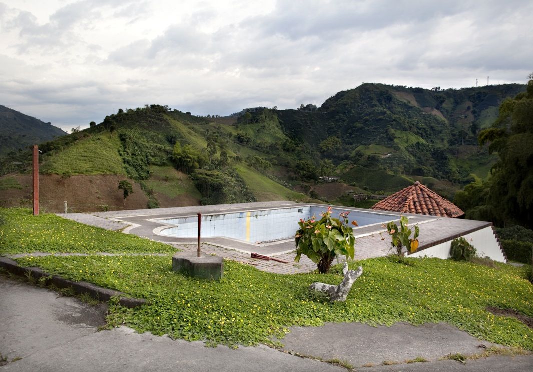 An empty swimming pool owned by a coffee farmer in Colombia. | www.eklectica.in All Over The World, Around The Worlds, Amazing Swimming Pools, Garden Bridge, South America, Sun Lounger, Farmer, Netherlands, Abandoned