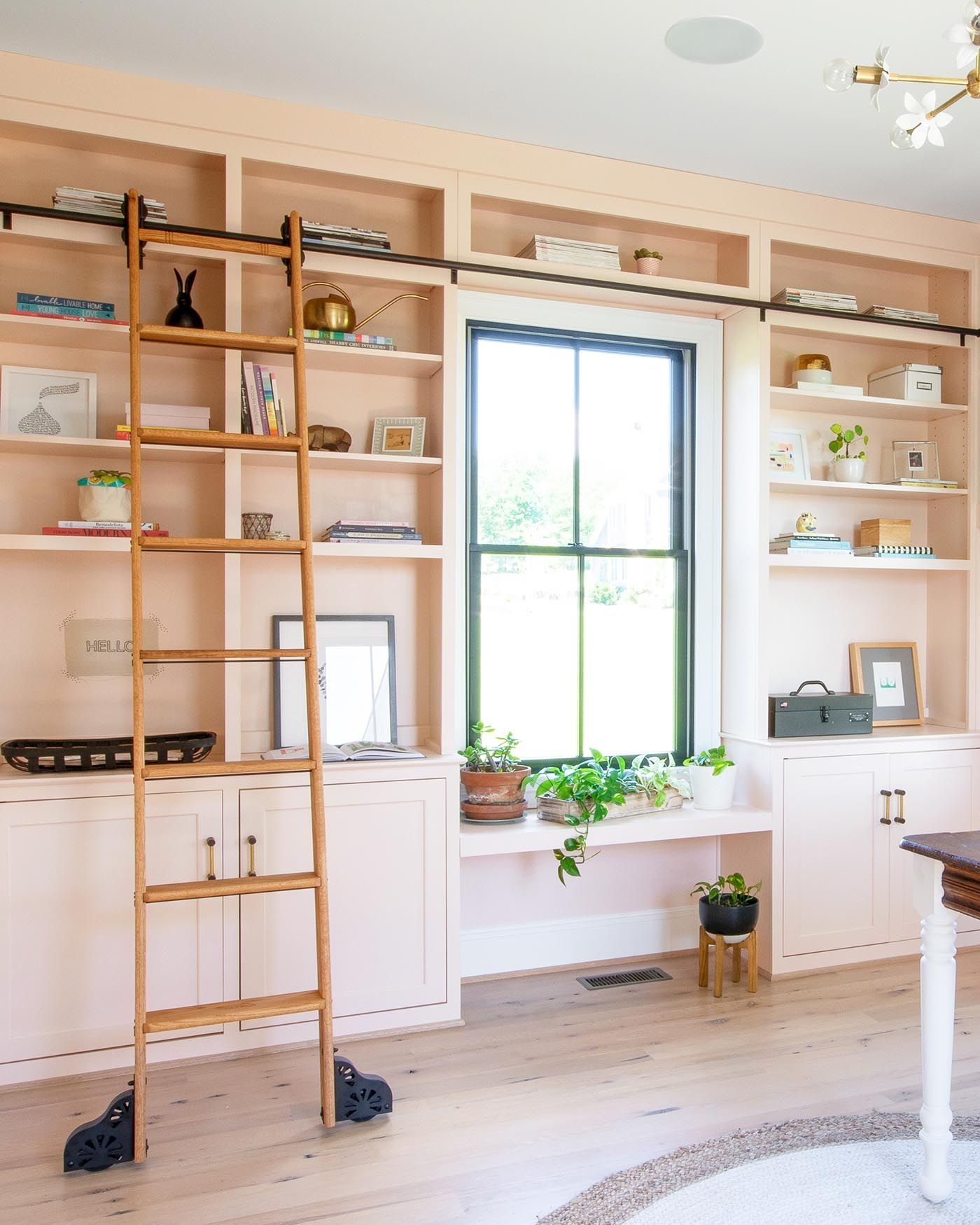 A sliding library ladder is the perfect complement to these pink DIY built-in bookshelves. The paint color is Wing It by Clare. Home office paint color is Wing It by Clare Home Office Shelves, Office Built Ins, Home Office Cabinets, Diy Built In Desk, Built In Bookcase, Built In Furniture, Bookshelves In Bedroom, Bookcases, Build In Bookshelves