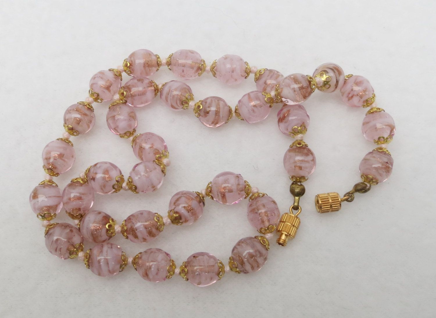 Murano lampwork pink green and rust glass beads with vintage pink crystal beads antique brass finish.