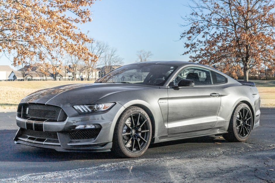This 2017 Ford Mustang Shelby GT350 is powered by a replacement 5.2-liter Voodoo V8 linked with a six-speed manual transmission and a Torsen limited-slip differential. The car is finished in Magnetic Metallic with black racing stripes over Ebony cloth and Miko suede and is equipped with the Electronics Package, 19" black wheels, Brembo brake calipers, a rear spoiler, a Bang & Olufsen sound system, a rearview camera, Recaro seats, a Steeda X-pipe, and a voice-activated touchscreen with naviga 2017 Ford Mustang, Ford Mustangs, Hidden Projector, Six Speed, Projector Headlights, Recaro, Black Wheels, Limited Slip Differential, Racing Stripes